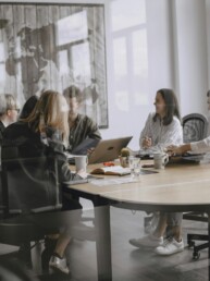 A small group seated around a meeting table &mdash; workshops and retreats with Cheryl Donaldson