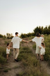 A family walking together through tall grass &mdash; clinical care and family therapy with Cheryl Donaldson